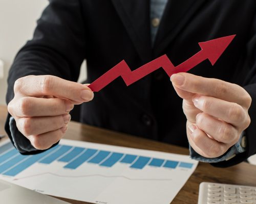 businessman-holding-growth-arrow-scaled-1